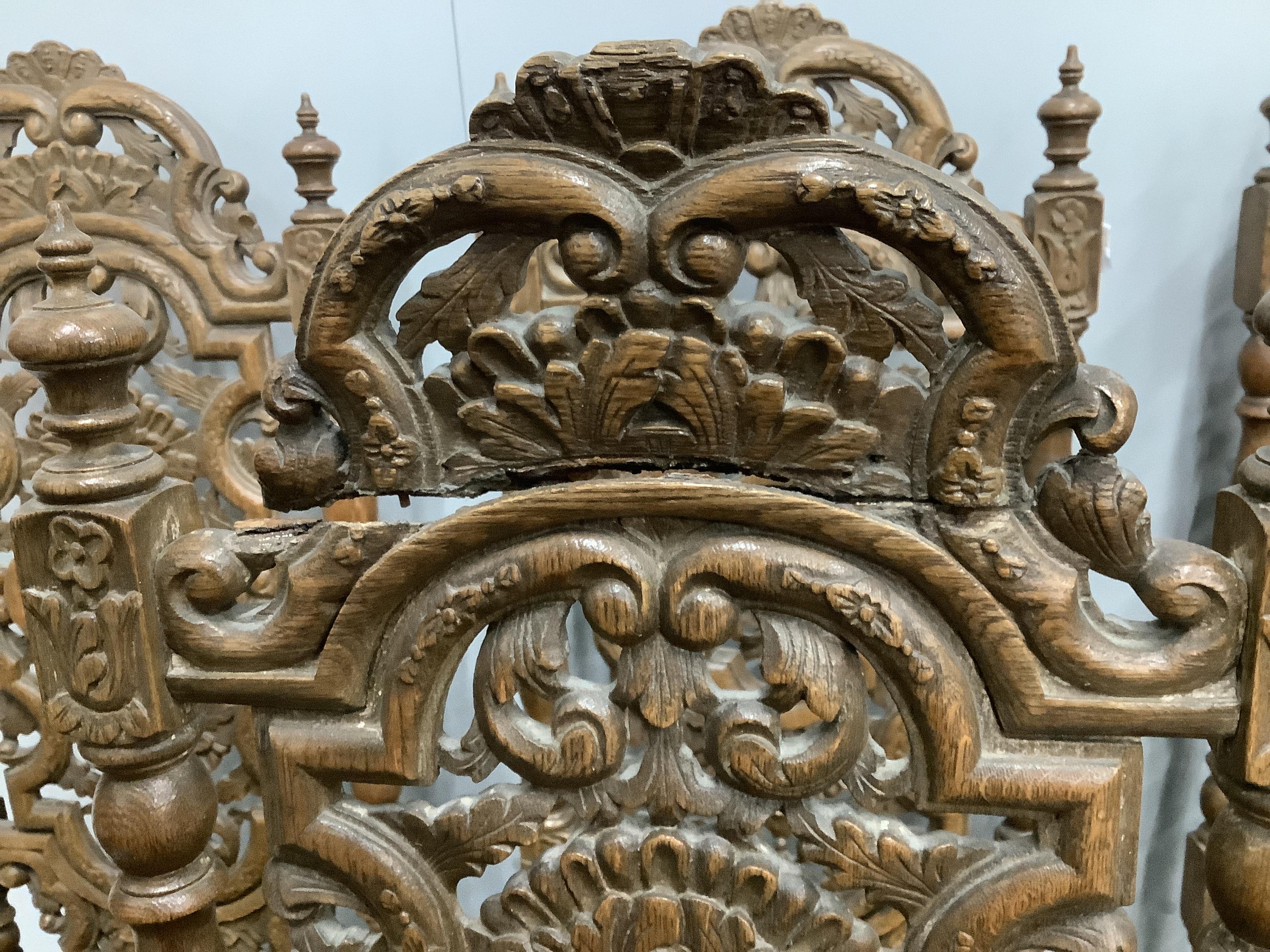 A matched set of six Louis XIV style carved oak high back dining chairs, width 46cm, height 124cm